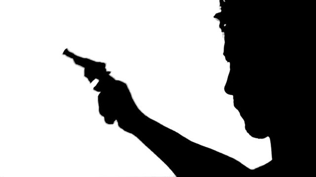 Silhouette of An Assassin Shooting A Gun. Silhouette of a man aiming with a gun over white background