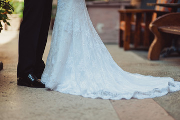 Fototapeta na wymiar Feet of the groom and bride on the walk