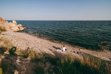Wedding couple on a walk bride and groom sea field sunset architecture grass sand