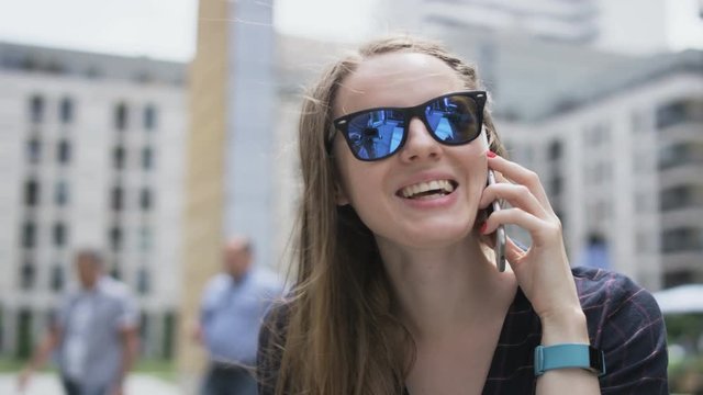 Woman With Dark Glasses Turning Left During a Phone Call