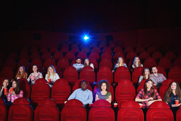 Cinema auditorium with spectators sitting watching a movie copyspace enjoyment recreation...