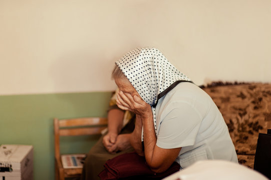 Old Woman Crying Covering Her Face With Her Hands