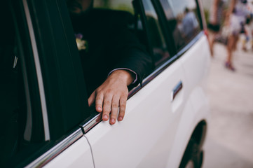 Man inside car showing his hand outdoor