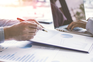 Business people meeting point to discuss, plan and chart the rise and fall of economic business concept.