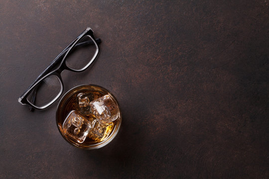 Whiskey with ice and eyeglasses