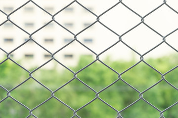 Fototapeta premium blur and soft focus steel net with the blur condominium and town home in the city. blur background.