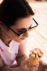 Girl in sunglasses eating ice cream