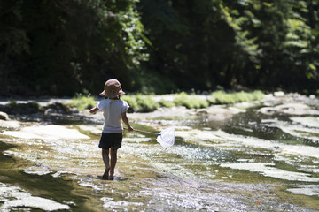 Happy Little Girl playing in the river