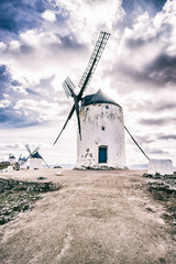The windmill against the cloudy sky