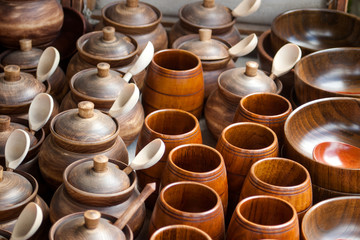 Counter with wooden utensils. Plates, spoons, cups, sugar bowls.