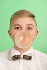 Boy blowing a bubblegum bubble.