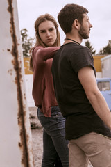 A guy and a girl are walking on the street