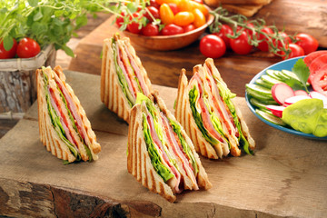 Fresh four sandwiches on wooden background