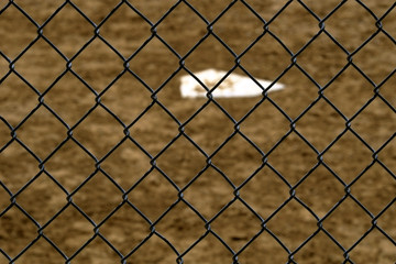 Fototapeta premium Baseball Home Plate and Backstop Fence