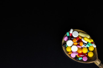 Wooden spoon with pills