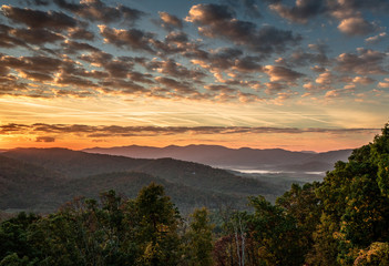 beautiful morning and sunrise over the Blue Ridge mountains in the North Carolina Appalachians with misty valleys and an expressive and colorful sky with clouds