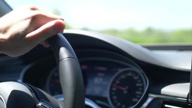Driving Modern Car. Cockpit View. Steering Wheel Closeup