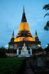 Naklejka premium Ancient white buddha statues and ruined pagoda at Wat Yai Chai Mongkol in Ayutthaya historic attractions ,Thailand.