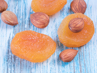 Dried apricots with nuts on wooden table close-up macro shot