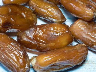 Dried date fruits on wooden background. Top view