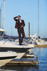 Obraz premium Handsome man on a regatta