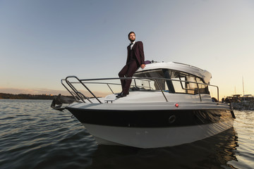 Man Standing On Front Of Luxury Yacht In Sea