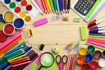 school and office supplies. school background. colored pencils, pen, pains, paper for  school and student education on wooden background. top view with copy space