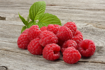 ripe raspberries on old wooden background