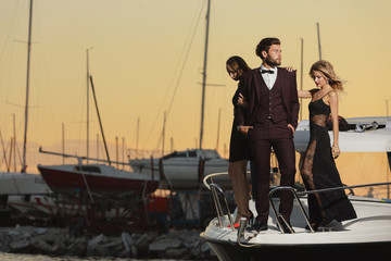 Stylish wealthy friends having fun on a luxury yacht