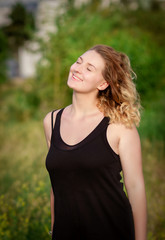 Fototapeta premium Young happy woman enjoys sun
