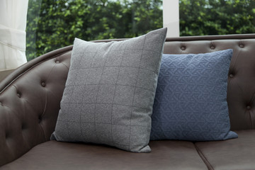 Gray Sofa with grey and Blue Pillows on Empty Lounge Room