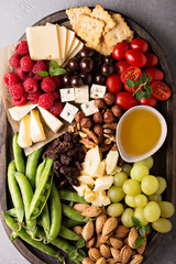 Cheese plate with fresh vegetables and fruits