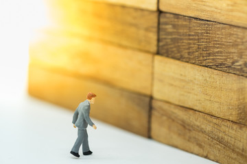 Business, Risk management, planning and exit concept. Businessman miniature figure walking on...