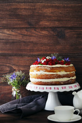 Delicious biscuit cake with berries on cake stand