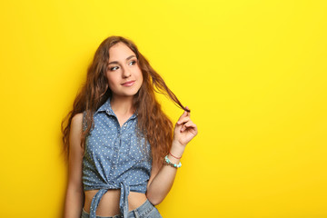 Portrait of young woman on yellow background