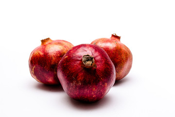 Three pomegranates isolated