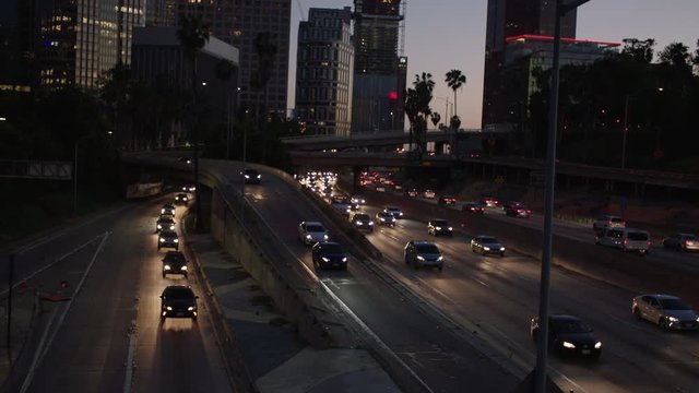 Freeway traffic in downtown Los Angeles at night. Evening Rush Hour Traffic. 4K
