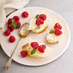 Open faced sandwiches with cheese, pears and raspberry