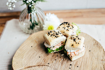 Selection of very tasty and delicious party snacks, little sandwiches with sesame seeds, gourmet food