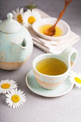 Camomille tea in handmade ceramic cup