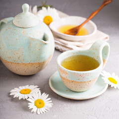 Camomille tea in handmade ceramic cup