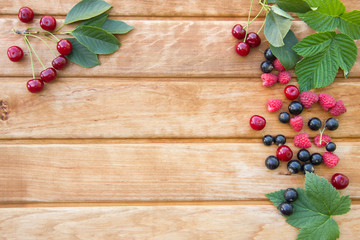 Berries on Wooden Background. Raspberries, Blueberry and Cherry. Summer or Spring Organic Berry over Wood.