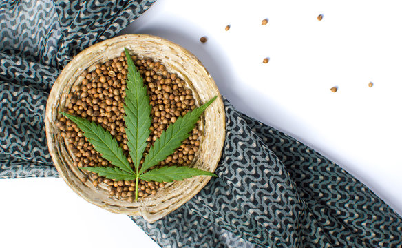Cannabis seeds in a bowl with dark  fabric
