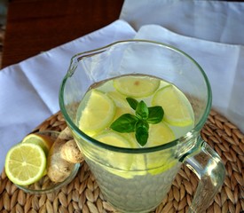 Fresh cold lemonade with a piece of lemon, ice and ginger on a glass.