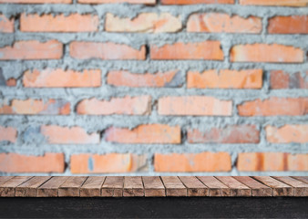 Wooden table with brick wall