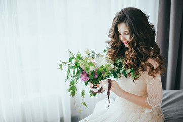 Bride with a beautiful bouquet of different colors.