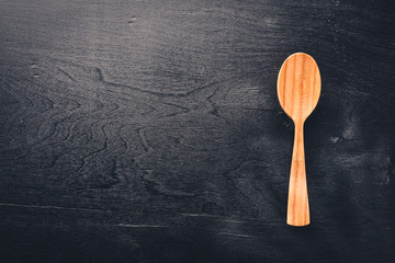 Wooden spoon on a black background Wooden.