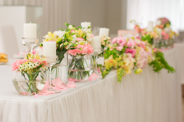 Wedding decorations, flowers and candles in restaurant. 