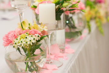 Wedding decorations, flowers and candles in restaurant. 