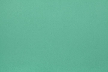 Green painted stucco wall. Background texture